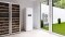 Air source heat pump: Indoor unit next to a wine rack and outdoor unit in the garden.