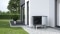 The picture shows the Viessmann Vitocal 222-A heat pump in front of a house wall.